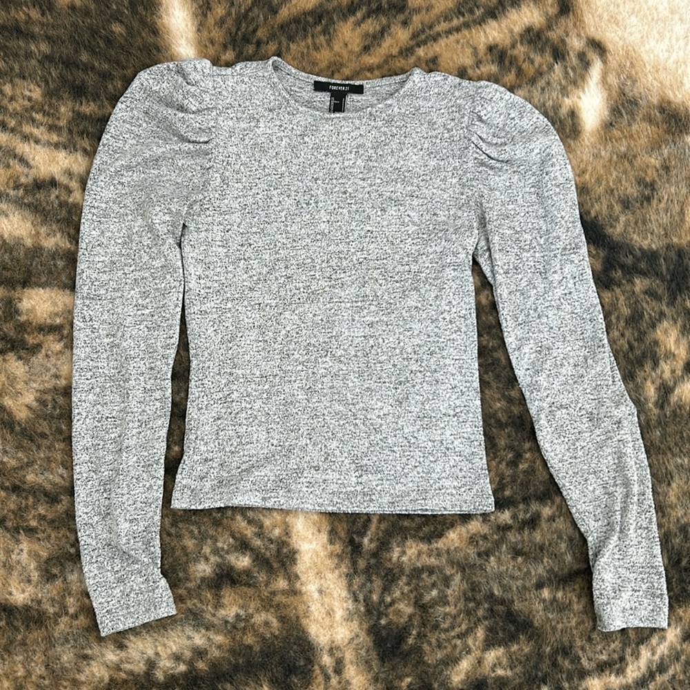 Ruffled shoulder, small long sleeve blouse.